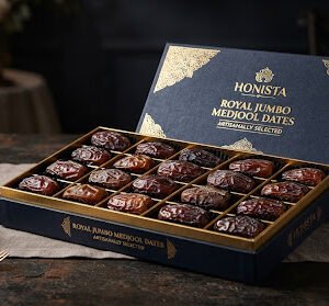 Artisanal Jumbo Medjool Dates arranged neatly in a royal gold stamped presentation box.