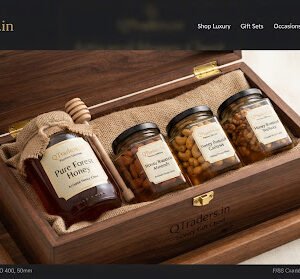 Exquisite honey chest with pure forest honey jar and three hexagonal jars of honey dipped roasted almonds, cashews and walnuts on ivory background