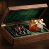 Luxurious dark walnut box lined with royal green velvet containing Madinah Ajwa dates and a hexagonal jar of raw golden Sidr honey tied with golden ribbon, warm golden lighting studio food photography