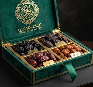 Luxury emerald green velvet keepsake gift box opened to reveal four partitioned compartments containing Ajwa, Medjool, Kalmi, and Sukkari dates, embossed with gold Arabic calligraphy crest and silk ribbon.